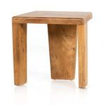 Compact outdoor accent stool in aged natural teak with a modern angular three-legged design
