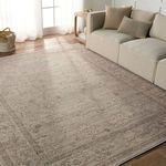 Camille floral rug featured in living room scene under sofa with pillows, near window with sheer curtains