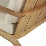 Angle showing joinery and construction details of teak armrest with cream cushion on sofa