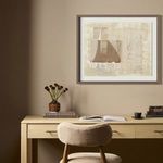 Different framed abstract artwork above desk with beige walls, chair, and vases visible