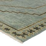 Close-up angled view highlighting texture and pile density of the geometric medallion blue-gray rug