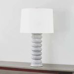 Harwinton Table Lamp lit with a slightly angled view against a plain wall