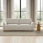 Callie Sofa styled in a bright room with large windows, light curtains, and wooden side table