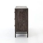 Close-up side view focusing on grain pattern and iron base leg supporting the dresser