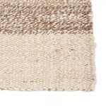 Natural jute area rug with a white border, flat woven texture in white and tan tones, coastal inspired design