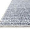 Close-up angled view showing textured weave and striped edge detail of Beverly Denim Rug