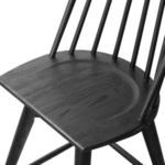Close-up of contoured wooden seat with smooth rounded edges in black wire-brushed oak