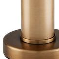 Detailed view of round brass base and cylindrical stem with soft brushed texture finish