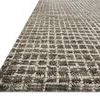 Angled close-up showing chunky wool texture and detailed intersecting grid pattern on rug
