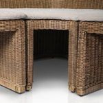 Close-up of square taupe cushion with pronounced button tufting on raised seats
