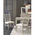 Two Splat Back Side Chairs in foreground with dining table and wall art in modern room with dark wood floors