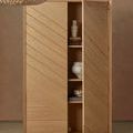 Monte Carlo vases inside open wooden cabinet with natural finish and chevron panel doors
