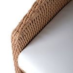 Wicker weave detail on extended chair leg creating the kickback shape