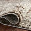 Close-up of rug edge curled to highlight texture and backing material