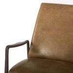 Close-up of olive green leather surface showing subtle distressed texture