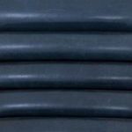 Close-up of padded horizontal channeling detail on chair back made of faux nubuck
