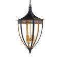 Close-up detail of gold candle arms and central ball decor inside black lantern frame