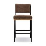 Benton Altair Mushroom Bar stool with slim black iron frame, solid oak base, and brown fabric seat and backrest