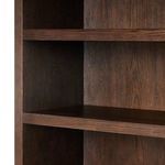 Close-up of two shelves and side panel meeting corner with visible wood grain texture