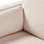 Close-up corner seating area of Toland sectional illustrating join of cushions in cream fabric