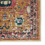 corner close-up highlighting detailed medallion patterns and rich pink and gold color variation