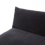 Edge detail of a cushion resting on armrest showing charcoal fabric and stitching