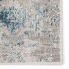 Close-up of distressed brocade pattern with mottled blue clusters and ivory-gray background