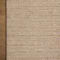 Partial view of rug corner on wooden floor highlighting subtle color variation and clean edges