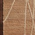 Detailed close-up of braided linear pattern and woven texture on ivory Bodhi Natural rug