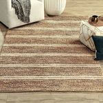 Barcelona rug styled in living room setting on wood floors with furniture and decor accents