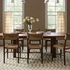 Bradley Ivory Beige Rug under dining table seen from opposite angle with window and curtains backdrop