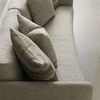 Close-up overhead view showing seat and back cushions with five throw pillows in beige and patterned fabric