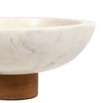 Close framing on bowl edge and wooden pedestal highlighting contrast of materials