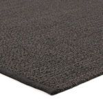Close-up angle highlighting rug edge binding and woven braided yarn composition