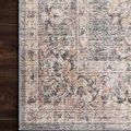 Close crop on floral and geometric pattern corner of Skye Grey Apricot Rug on dark wood floor