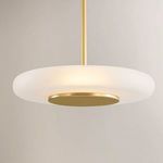 Pendant light illuminated, showing warm glow through frosted glass shade