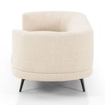 Side view of sofa showing rounded armrest and seat depth with visible upholstery texture