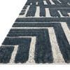 Low-angle close-up showing thickness and high-low pile texture of blue and white rug