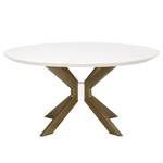 round dining table viewed straight on showing brass legs splayed and joined at center under ivory concrete top