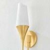 Close-up angled view highlighting fluted details of opal shade and rounded wall mount in aged brass finish