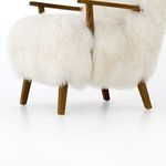 Detail showing drifted oak armrest in contrast with fluffy cream-fur fabric