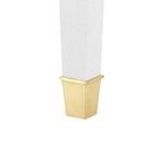 Close-up of gold metal cap on the tapered white washed lacquered linen table leg