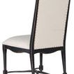 Rear view showing chair’s curved back and tapered legs with distressed black finish and nail trim details
