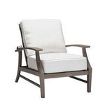 Weathered teak recliner chair with off-white cushions, front angle with relaxed seating