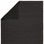 Top corner folded back revealing black non-slip rug backing texture