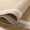 Curled edge of Easton Wheat Ivory rug displaying weave and flexible polypropylene material
