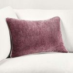 Pillow styled on a white sofa showcasing contrast between rich purple and light furniture