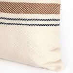 Angled close-up of pillow edge with navy and gold stripes and visible fabric weave