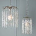 Pair of Glen Arbor pendants hanging against light blue wall showing size contrast and chain detail