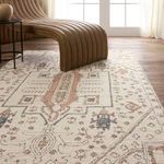 Rug under curved bench in airy room with muted jewel colors and subtle vintage distressing